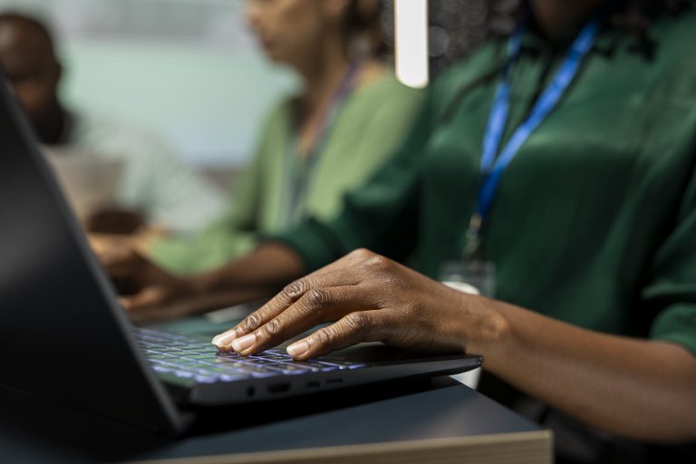 Close up of black female analyst reviews budget and expenses on laptop